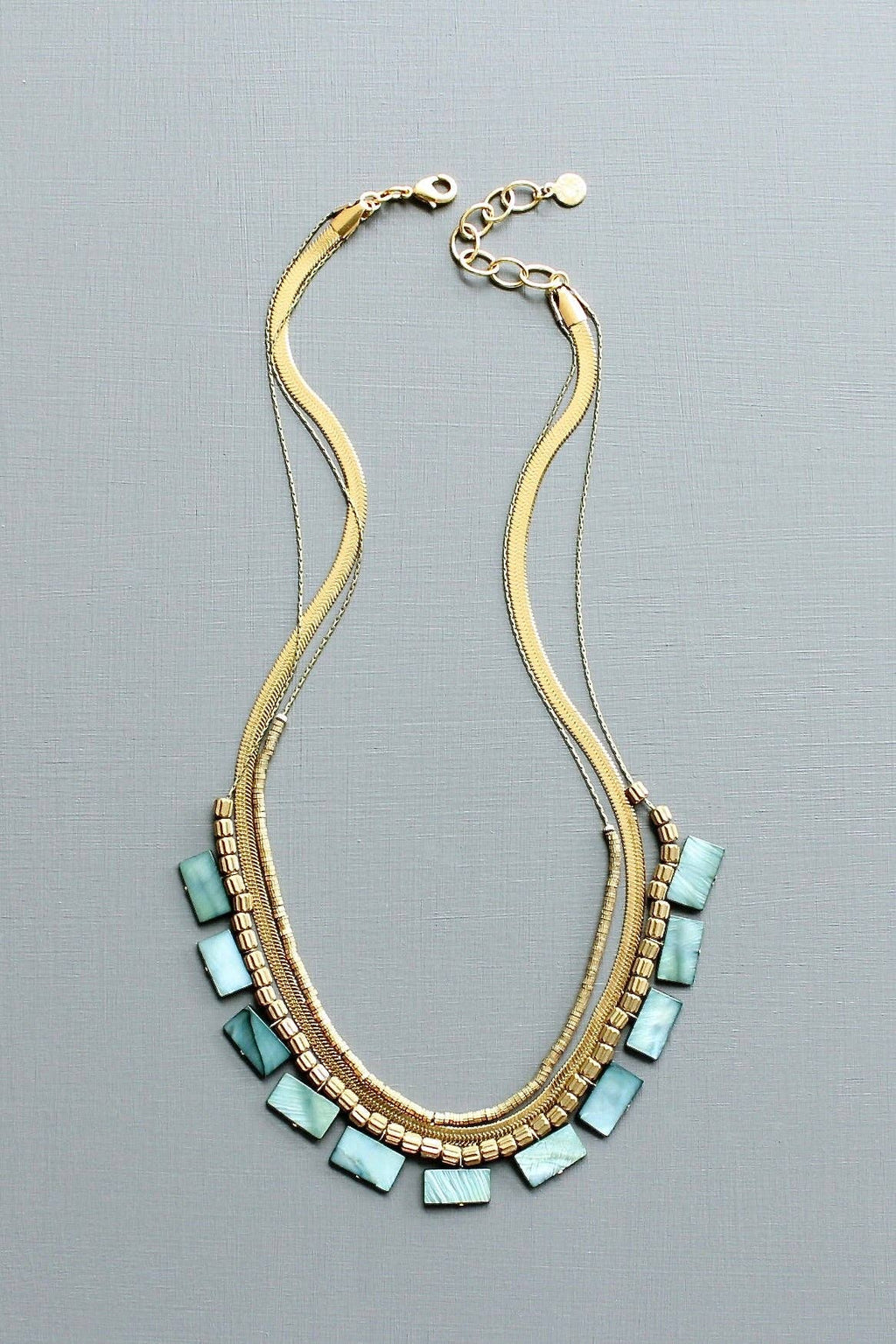 Green shell and snake chain triple-strand necklace