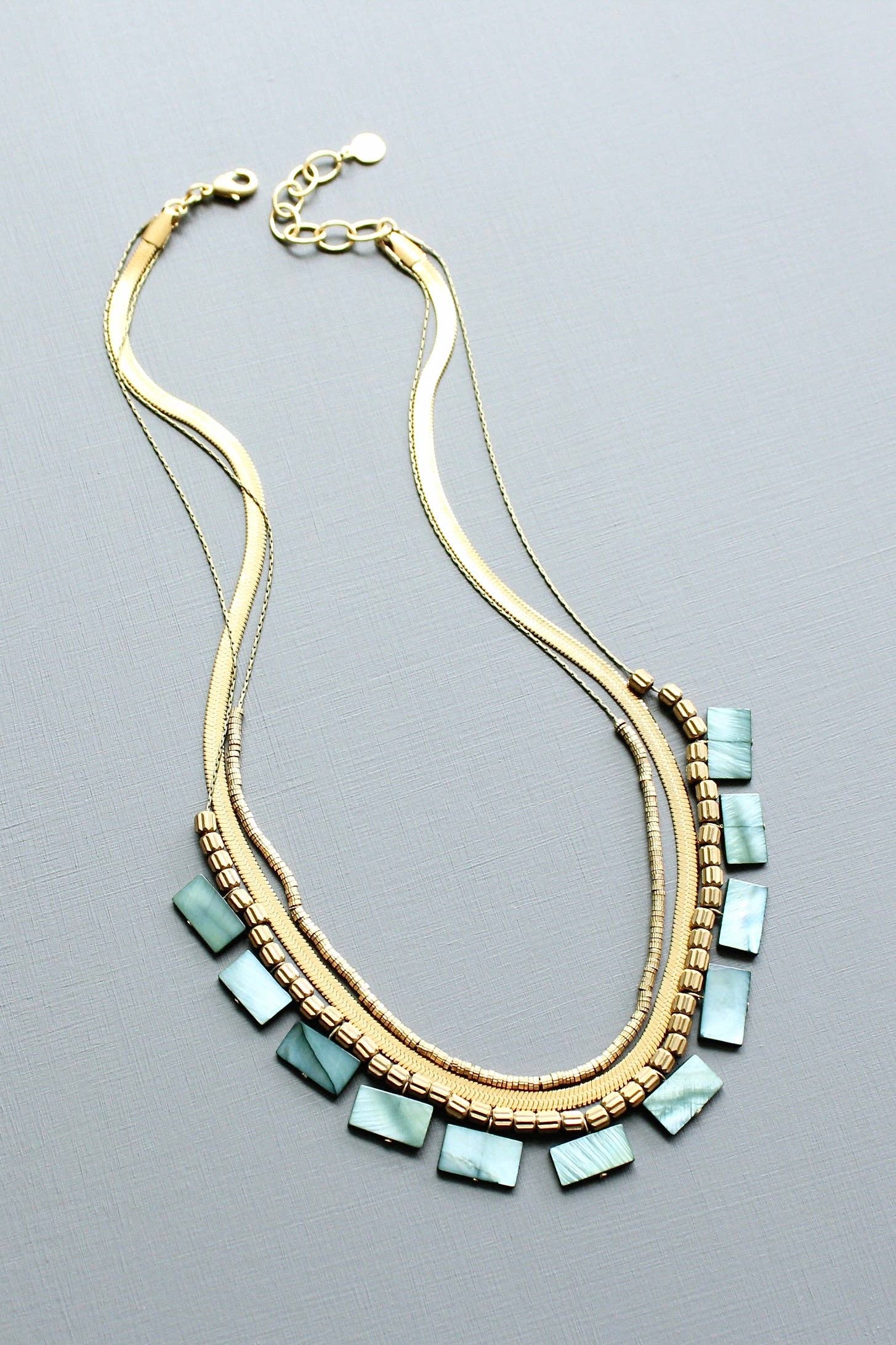 Green shell and snake chain triple-strand necklace