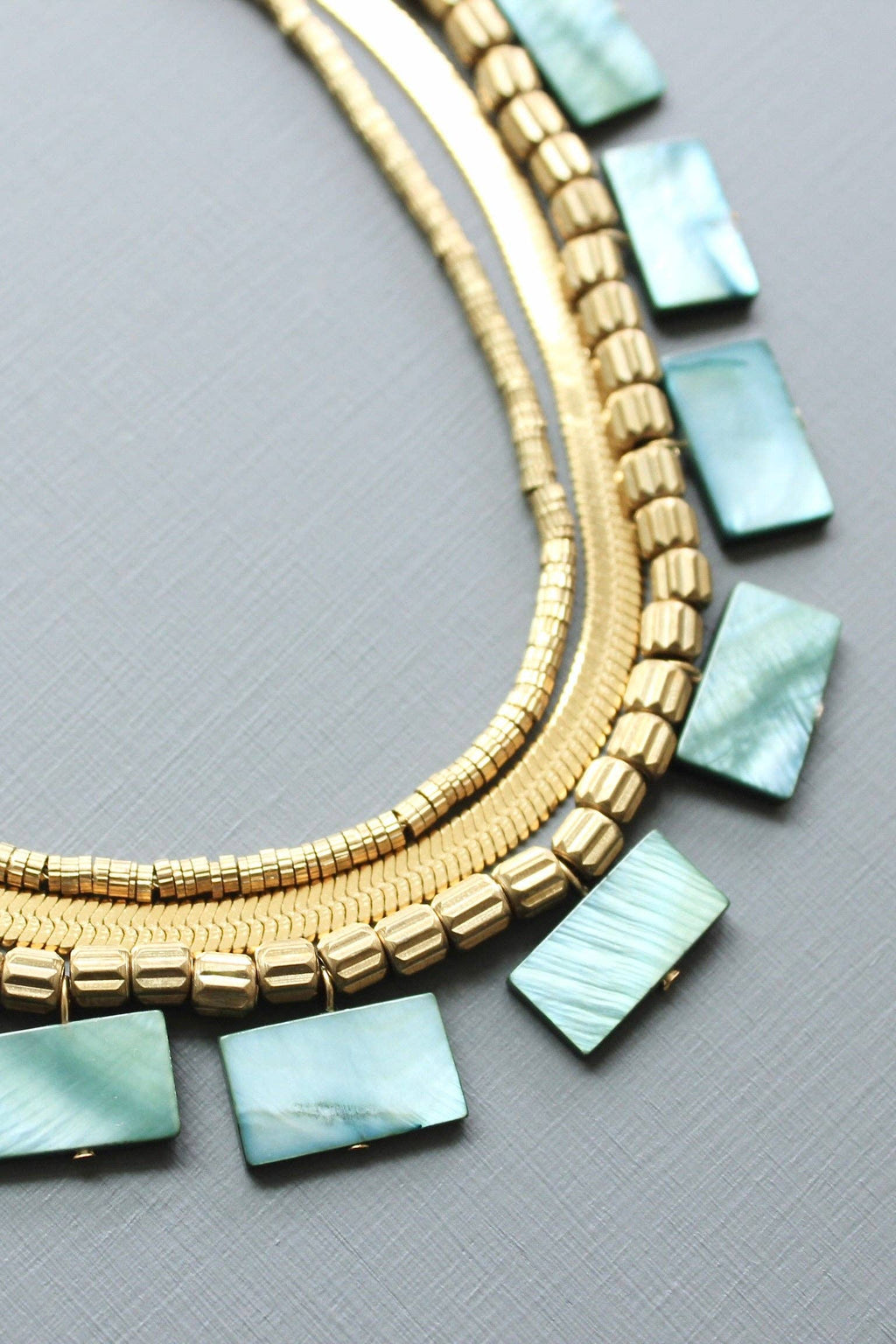 Green shell and snake chain triple-strand necklace