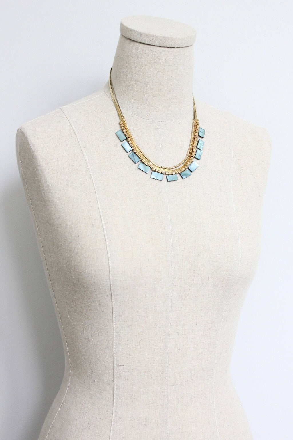 Green shell and snake chain triple-strand necklace